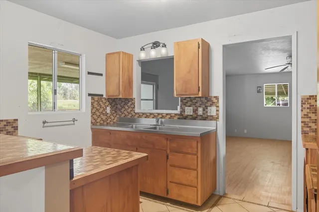 a kitchen with stainless steel appliances granite countertop a sink and a stove