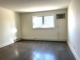 794 Broadway, Unit 3 Bayonne, NJ 07002 - Photo 3 of 12 an empty room with wooden floor and windows