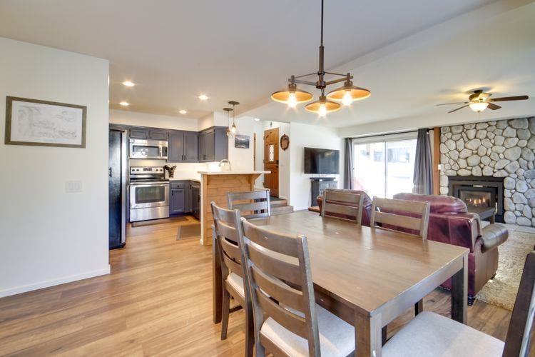 591 Golden Creek Road, Unit 591 Mammoth Lakes, CA 93546 - Photo 6 of 19 a view of a dining room and livingroom with furniture wooden floor a chandelier