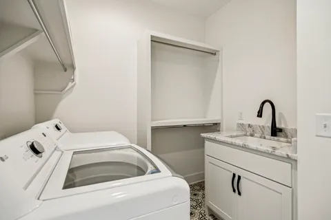 a bathroom with sinks granite vanity and a granite countertop mirror