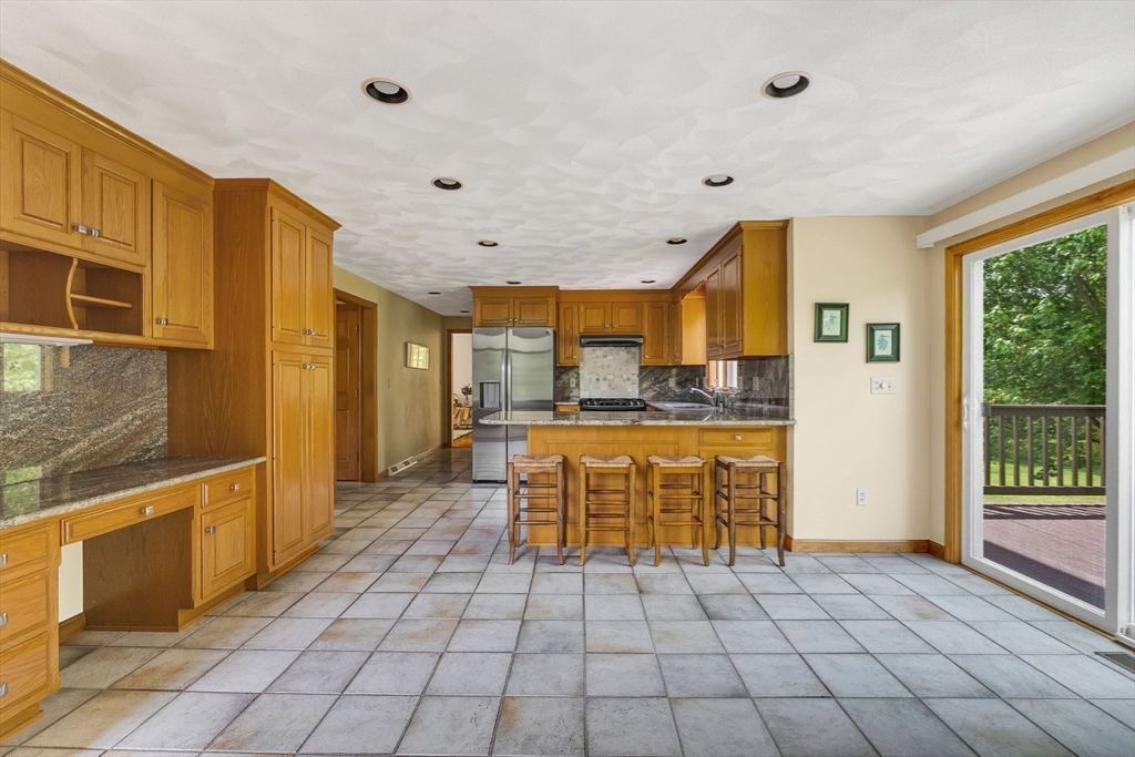 83 Jefferson Road Franklin, MA 02038 - Photo 7 of 34 a kitchen with stainless steel appliances granite countertop a refrigerator and a stove top oven