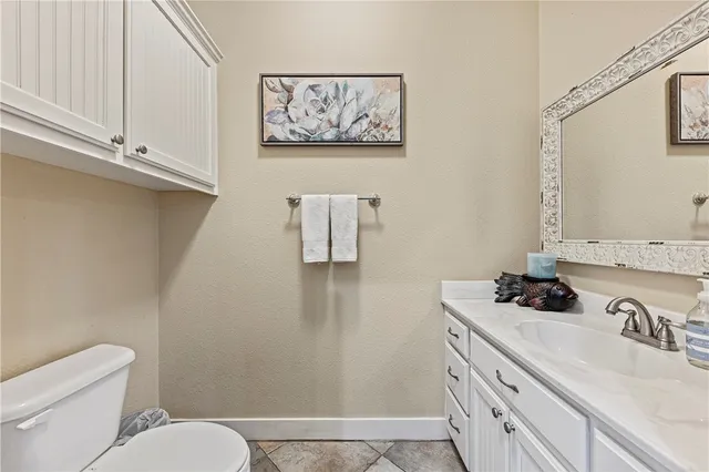 a bathroom with a sink a toilet and vanity