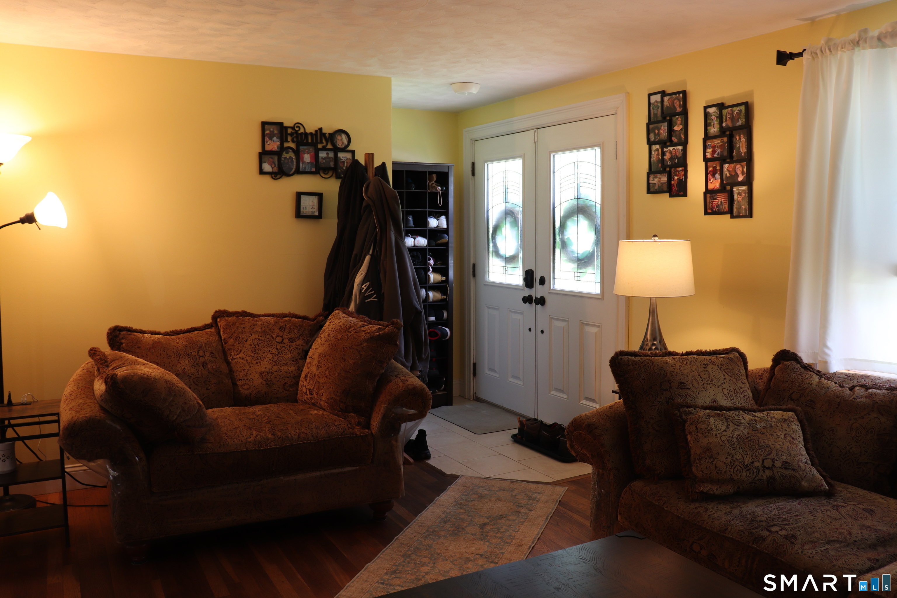 308 Abbe Road Enfield, CT 06082 - Photo 10 of 33 a living room with furniture a lamp and a window