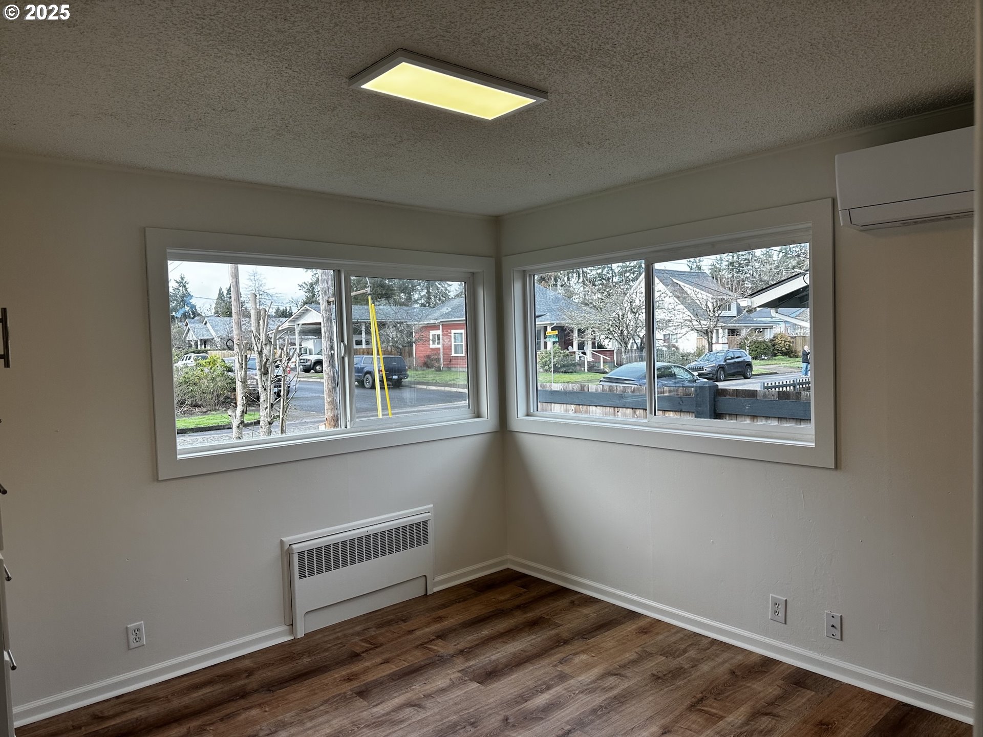 818 South 1st Street Cottage Grove, OR 97424 - Photo 16 of 22 an empty room with wooden floor and windows