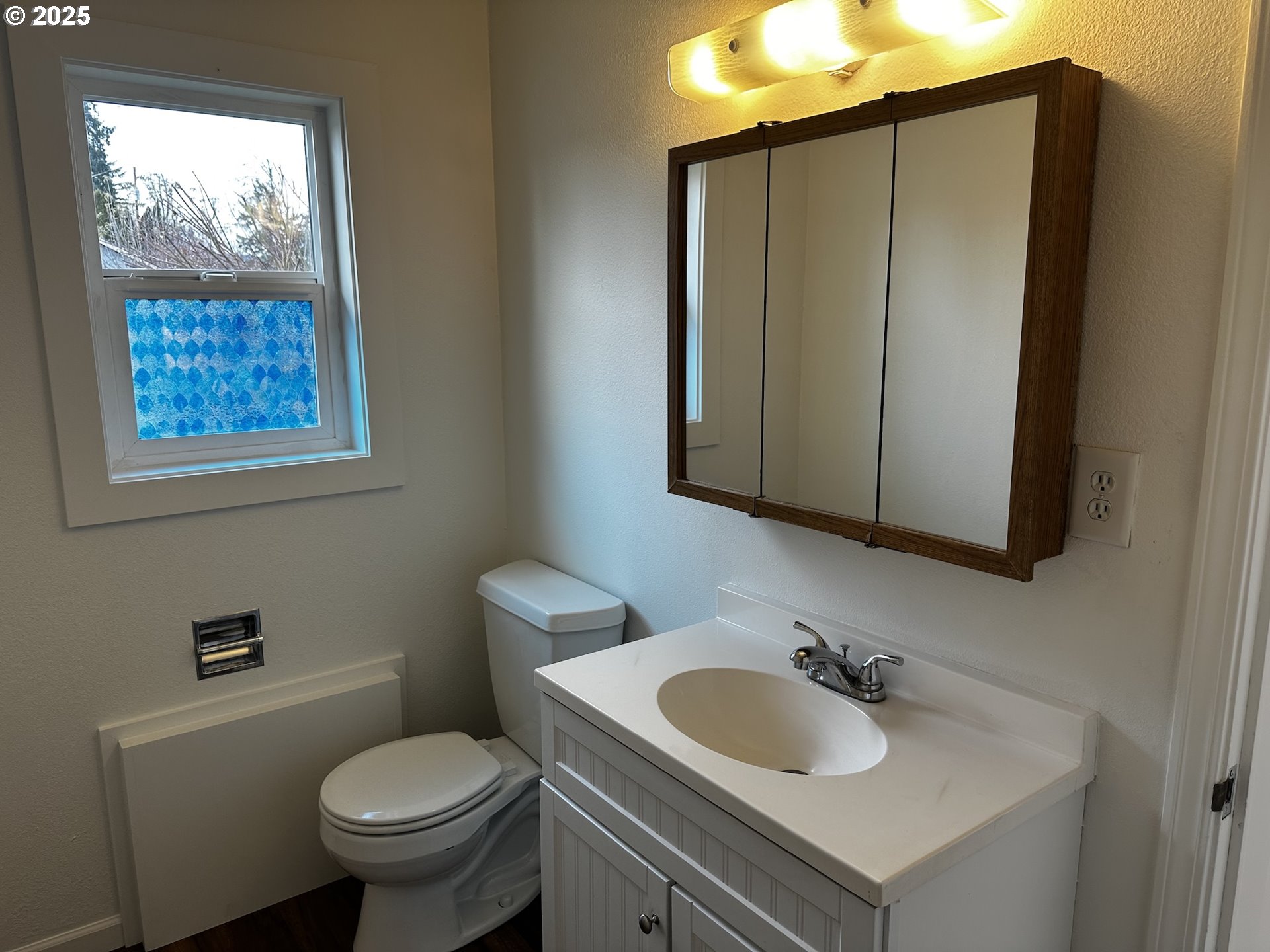 818 South 1st Street Cottage Grove, OR 97424 - Photo 18 of 22 a bathroom with a toilet sink and mirror