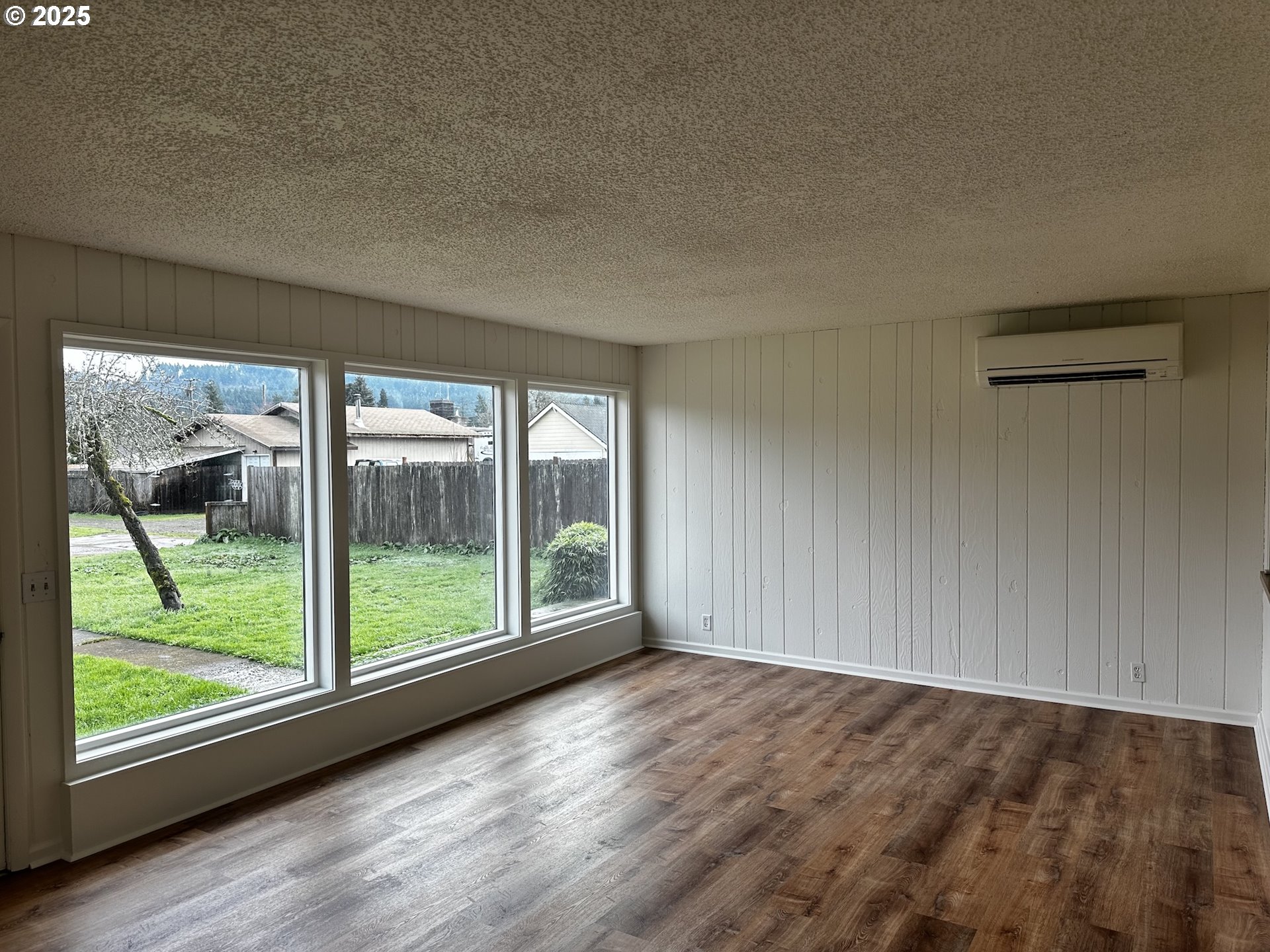 818 South 1st Street Cottage Grove, OR 97424 - Photo 7 of 22 wooden floor in an empty room with a window