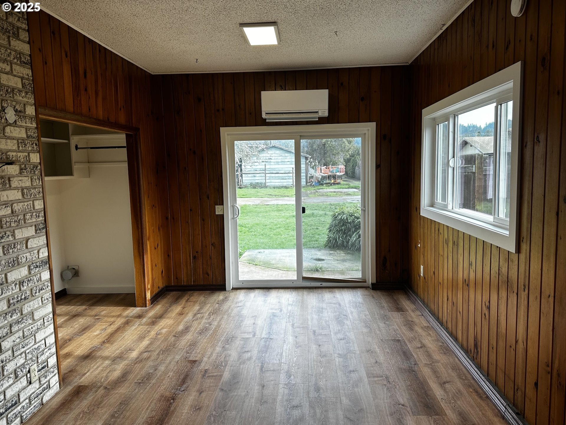 818 South 1st Street Cottage Grove, OR 97424 - Photo 10 of 22 an empty room with wooden floor and windows