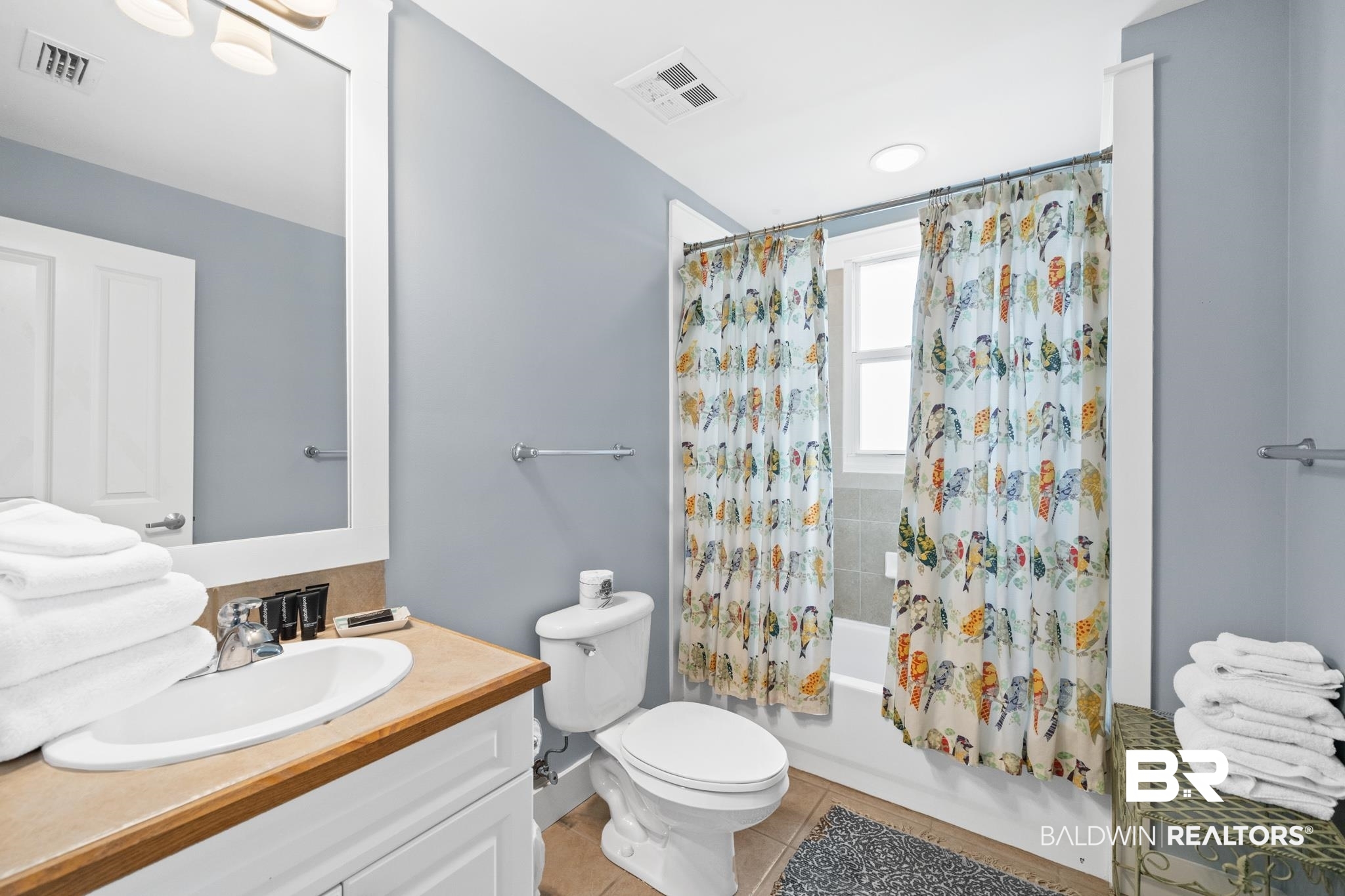 815 Plantation Road, Unit 405 Gulf Shores, AL 36542 - Photo 15 of 39 Full bathroom with tile patterned floors, toilet, shower / bath combo, and vanity