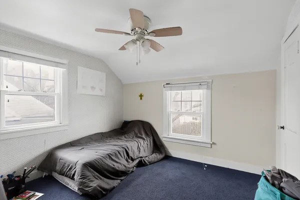 a bedroom with a bed and window