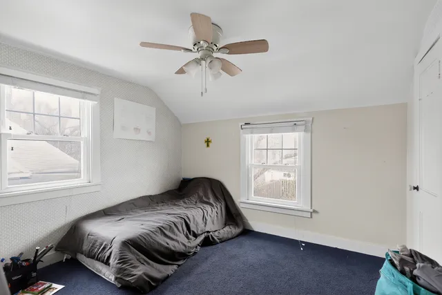 a bedroom with a bed and window