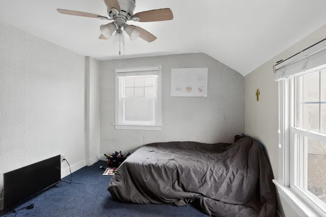 a bedroom with a bed and window