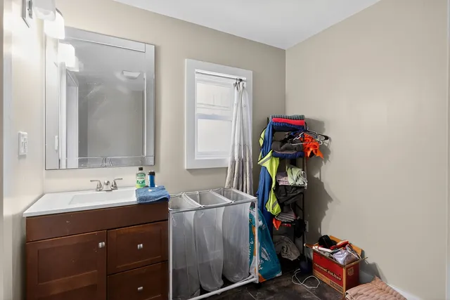 a bathroom with a sink a toilet and mirror