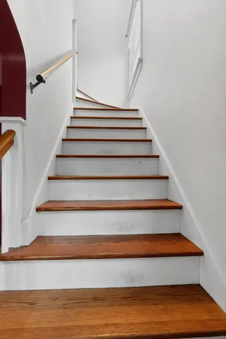 a view of a hallway with a livingroom and entryway