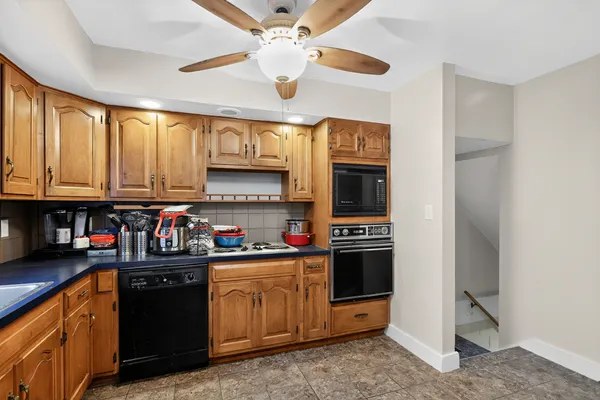 a kitchen with stainless steel appliances granite countertop a stove cabinets and refrigerator