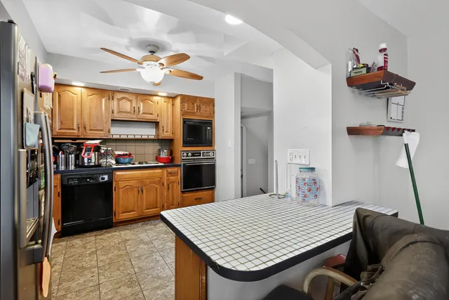 a kitchen with stainless steel appliances granite countertop a sink dishwasher stove and refrigerator