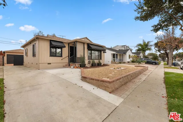 a view of a white house with a yard