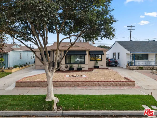 a front view of a house with a porch and a yard