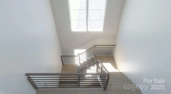 a view of a hallway with a livingroom and a bathroom