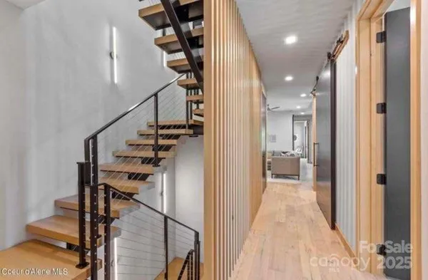 a view of entryway and hall with wooden floor