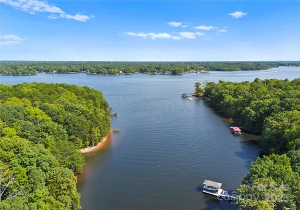 a view of a lake with houses in the back