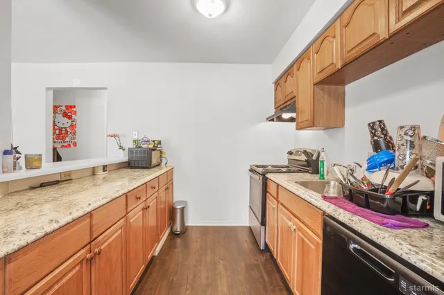 a kitchen that has a sink and a stove