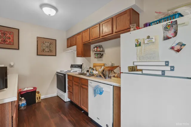 a kitchen with stainless steel appliances granite countertop a stove and a refrigerator