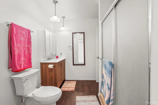 a bathroom with a toilet a sink and a mirror