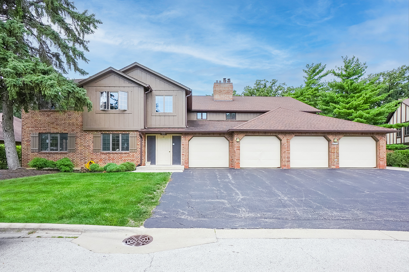 13222 South Oak Ridge Trail, Unit 1A Palos Heights, IL 60463 - Photo 1 of 21 a front view of a house with a yard and garage