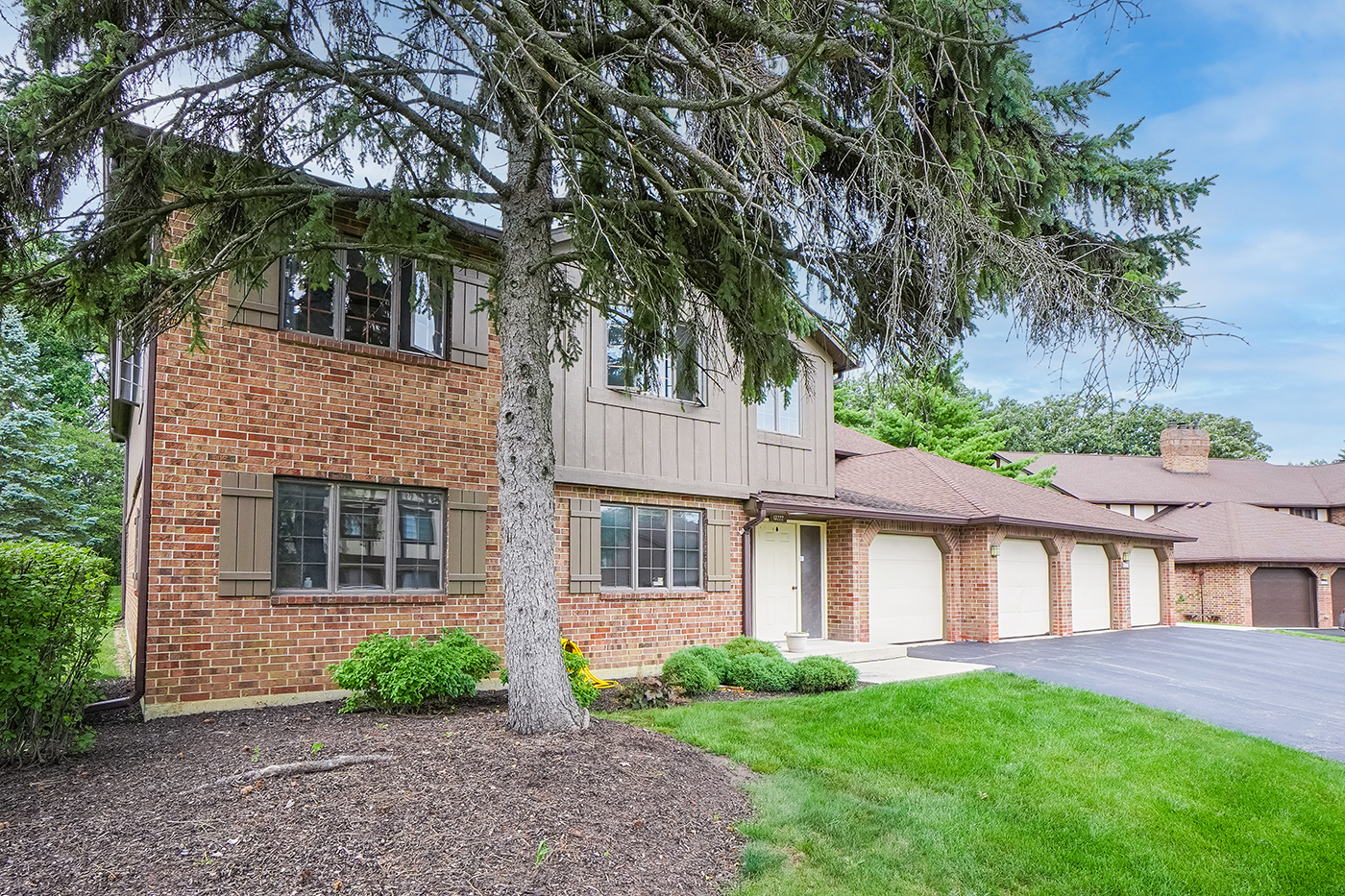 13222 South Oak Ridge Trail, Unit 1A Palos Heights, IL 60463 - Photo 2 of 21 a front view of a house with a garden