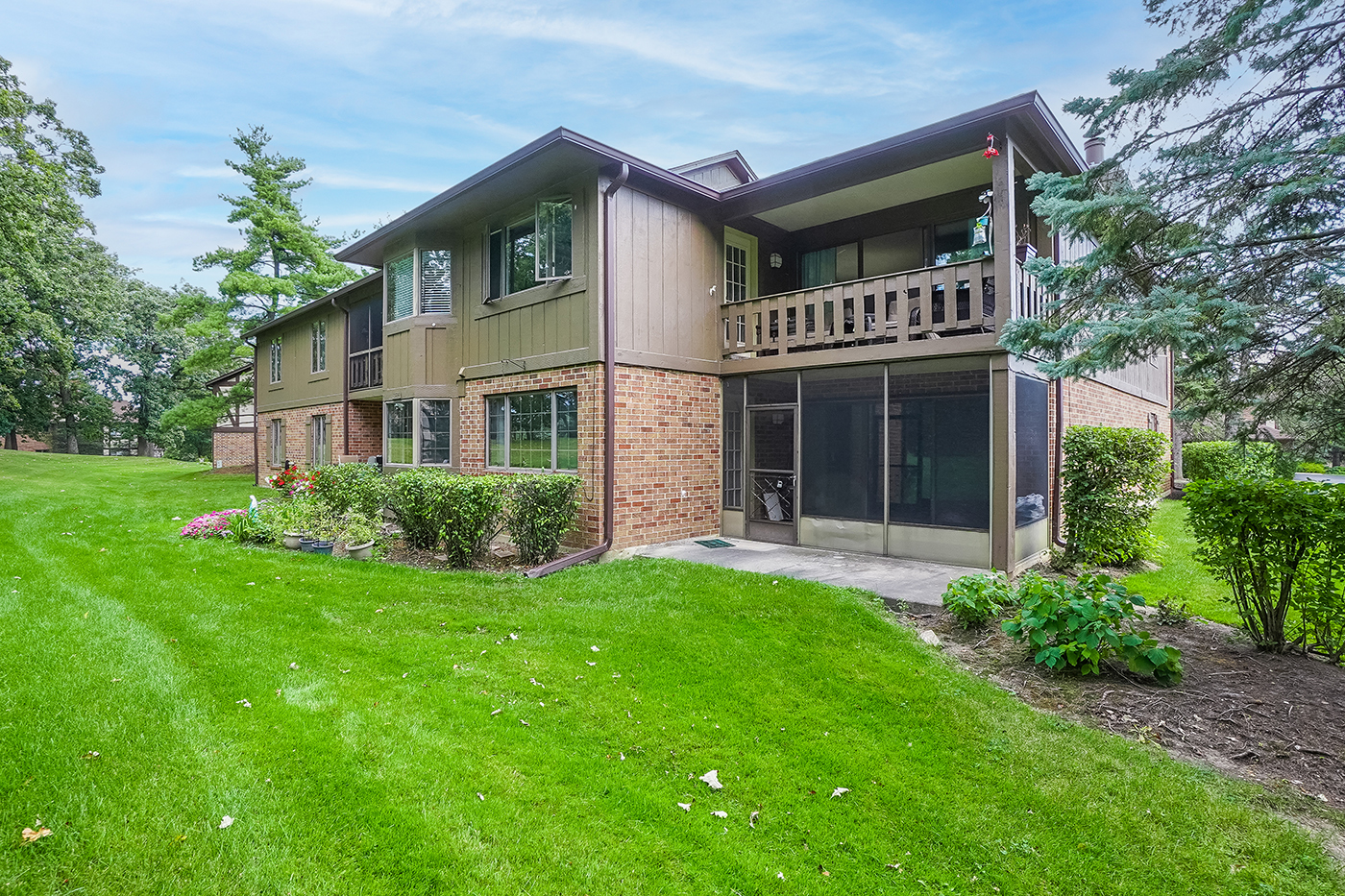 13222 South Oak Ridge Trail, Unit 1A Palos Heights, IL 60463 - Photo 21 of 21 a front view of a house with a garden and yard