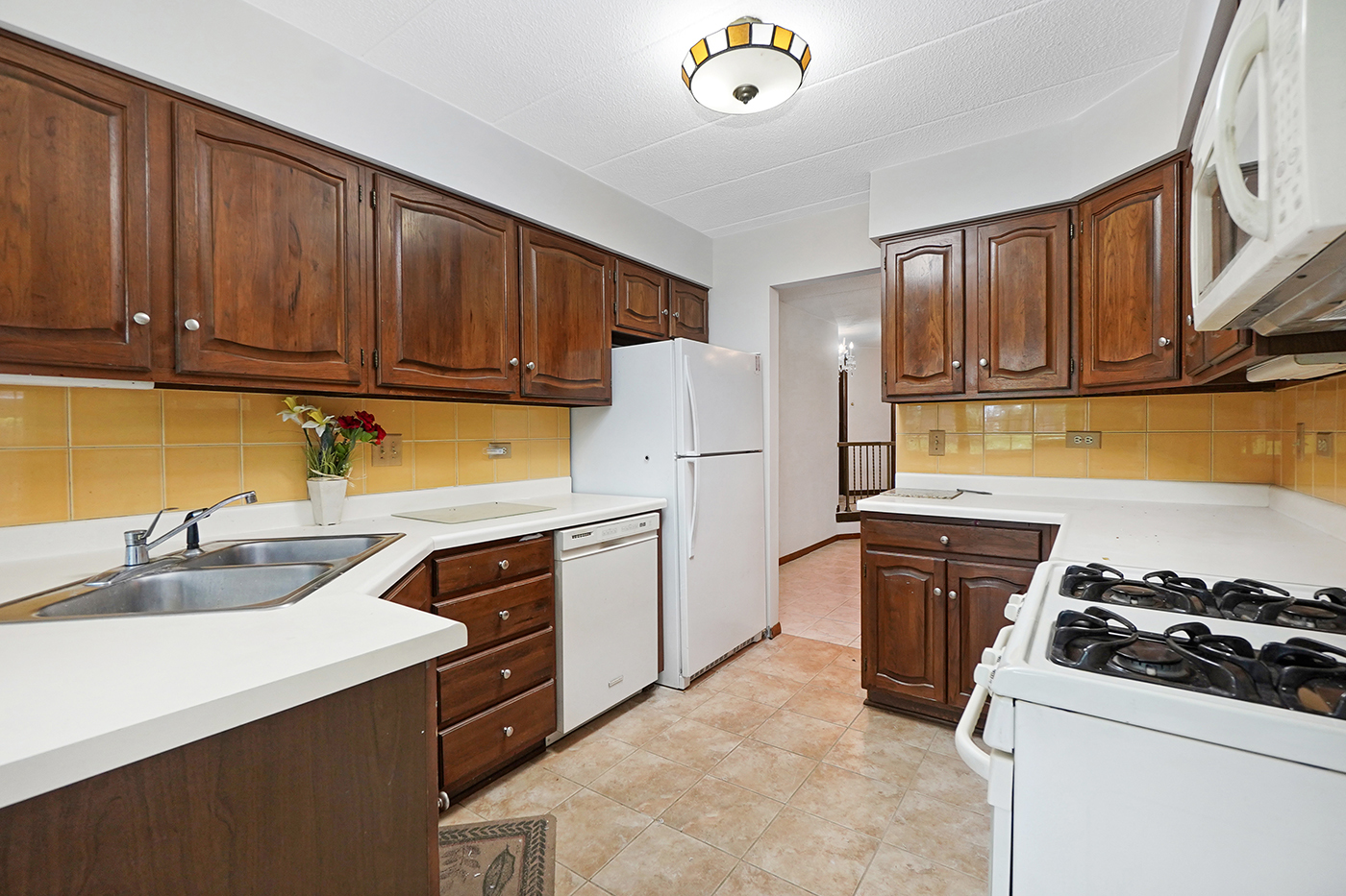 13222 South Oak Ridge Trail, Unit 1A Palos Heights, IL 60463 - Photo 7 of 21 a kitchen with stainless steel appliances granite countertop a sink stove and refrigerator
