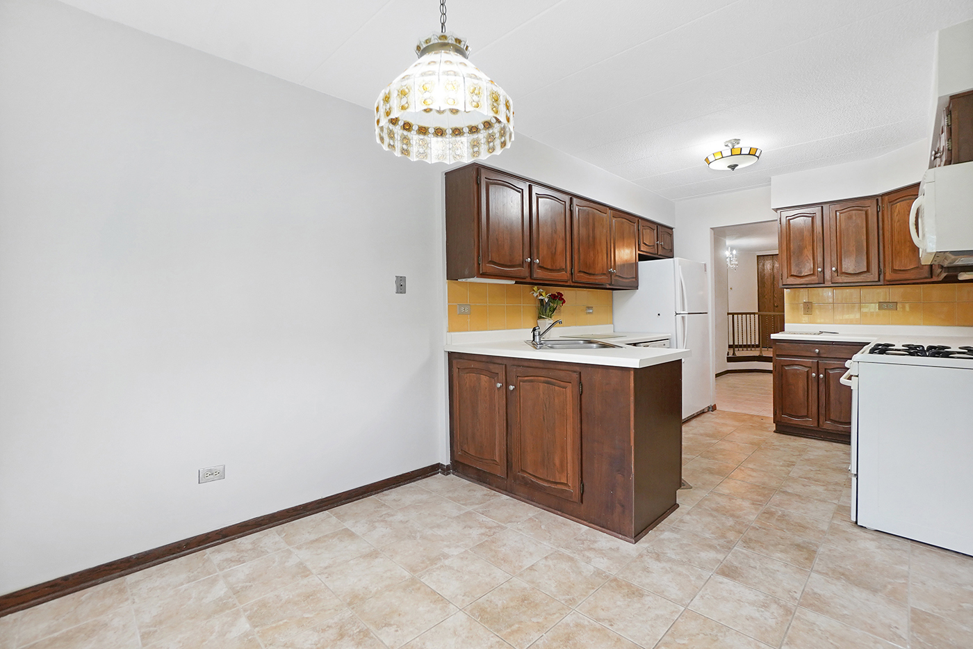 13222 South Oak Ridge Trail, Unit 1A Palos Heights, IL 60463 - Photo 8 of 21 a kitchen with kitchen island granite countertop a stove top oven a sink dishwasher and a microwave oven on the blue kitchen countertops