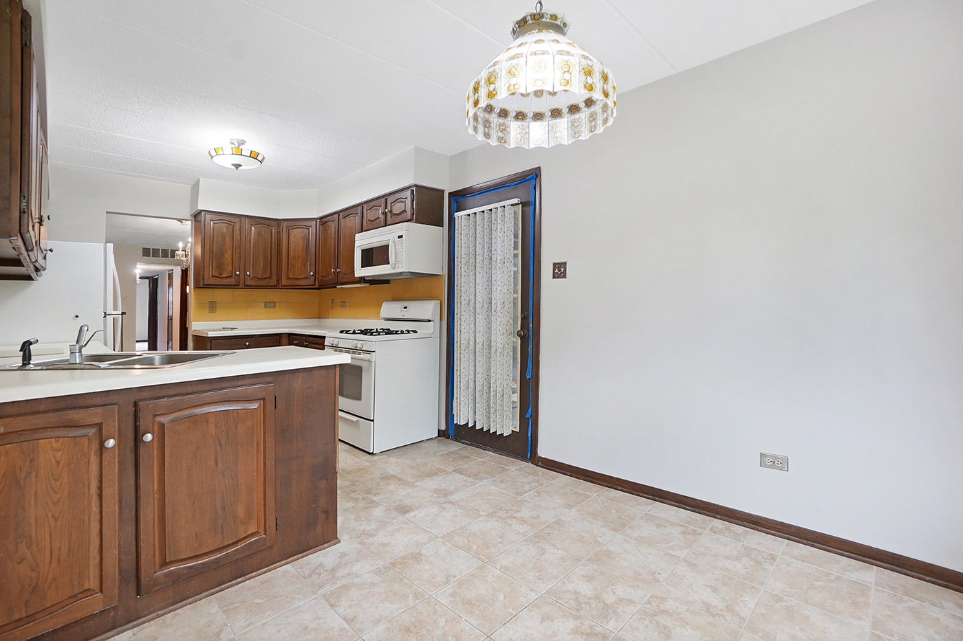 13222 South Oak Ridge Trail, Unit 1A Palos Heights, IL 60463 - Photo 9 of 21 a kitchen with stainless steel appliances granite countertop a refrigerator and a sink