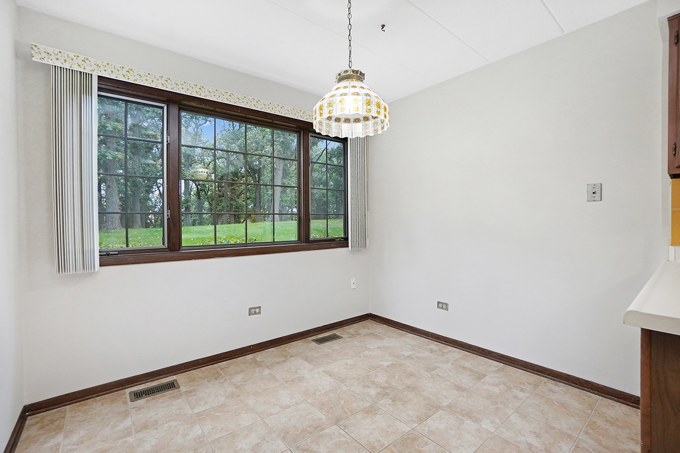 13222 South Oak Ridge Trail, Unit 1A Palos Heights, IL 60463 - Photo 10 of 21 a view of an empty room with wooden floor and a window