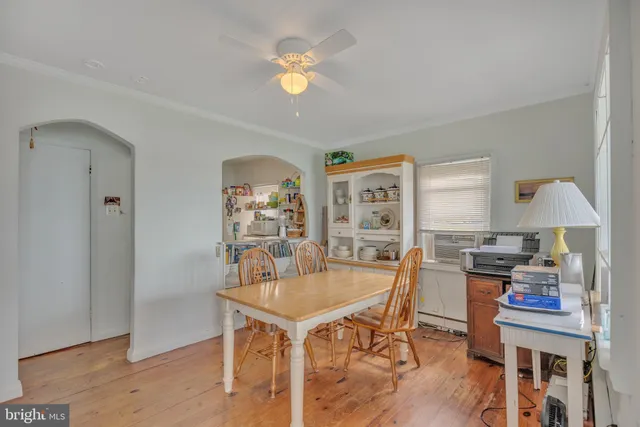 a view of a a dining room with furniture window and wooden floor