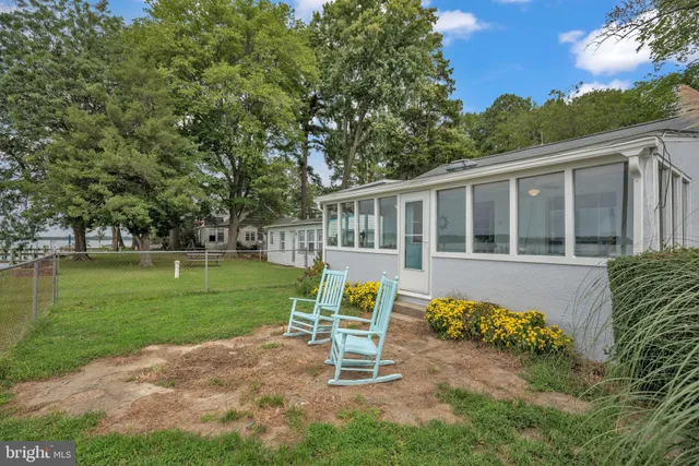 a view of a house with a yard table and chairs