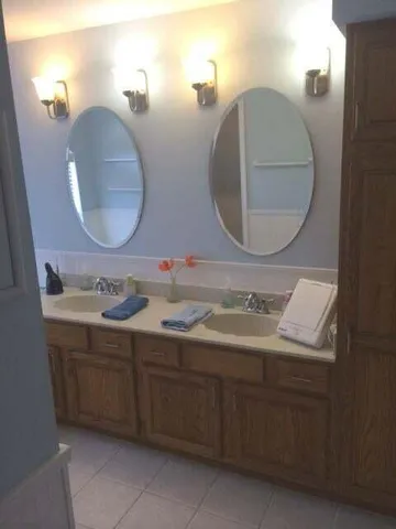 a bathroom with a granite countertop sink and a bathtub