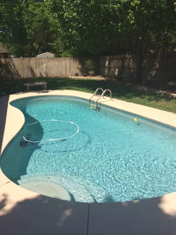a swimming pool with outdoor seating