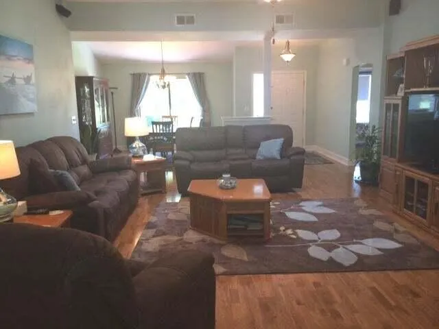 a living room with furniture and a large mirror