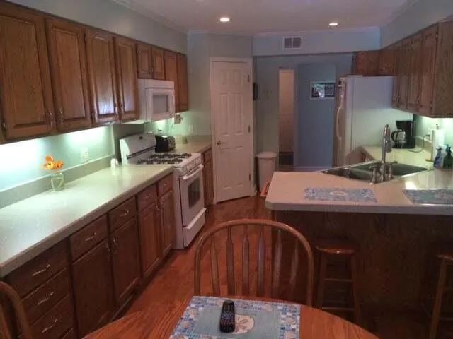 a view of a dining room with furniture wooden floor and chandelier