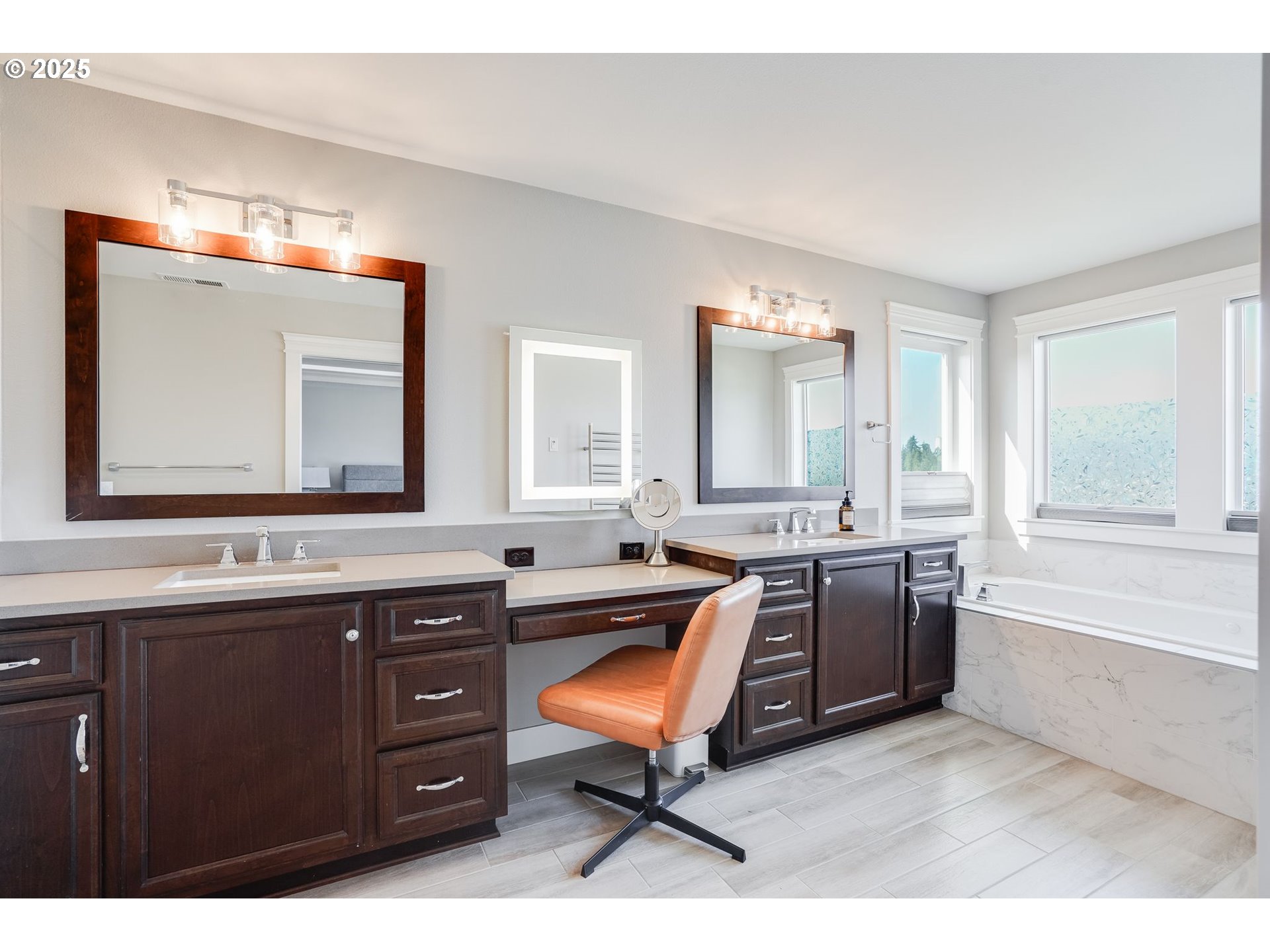 1709 South 43rd Place Ridgefield, WA 98642 - Photo 15 of 24 a room with a chair a sink and a large mirror