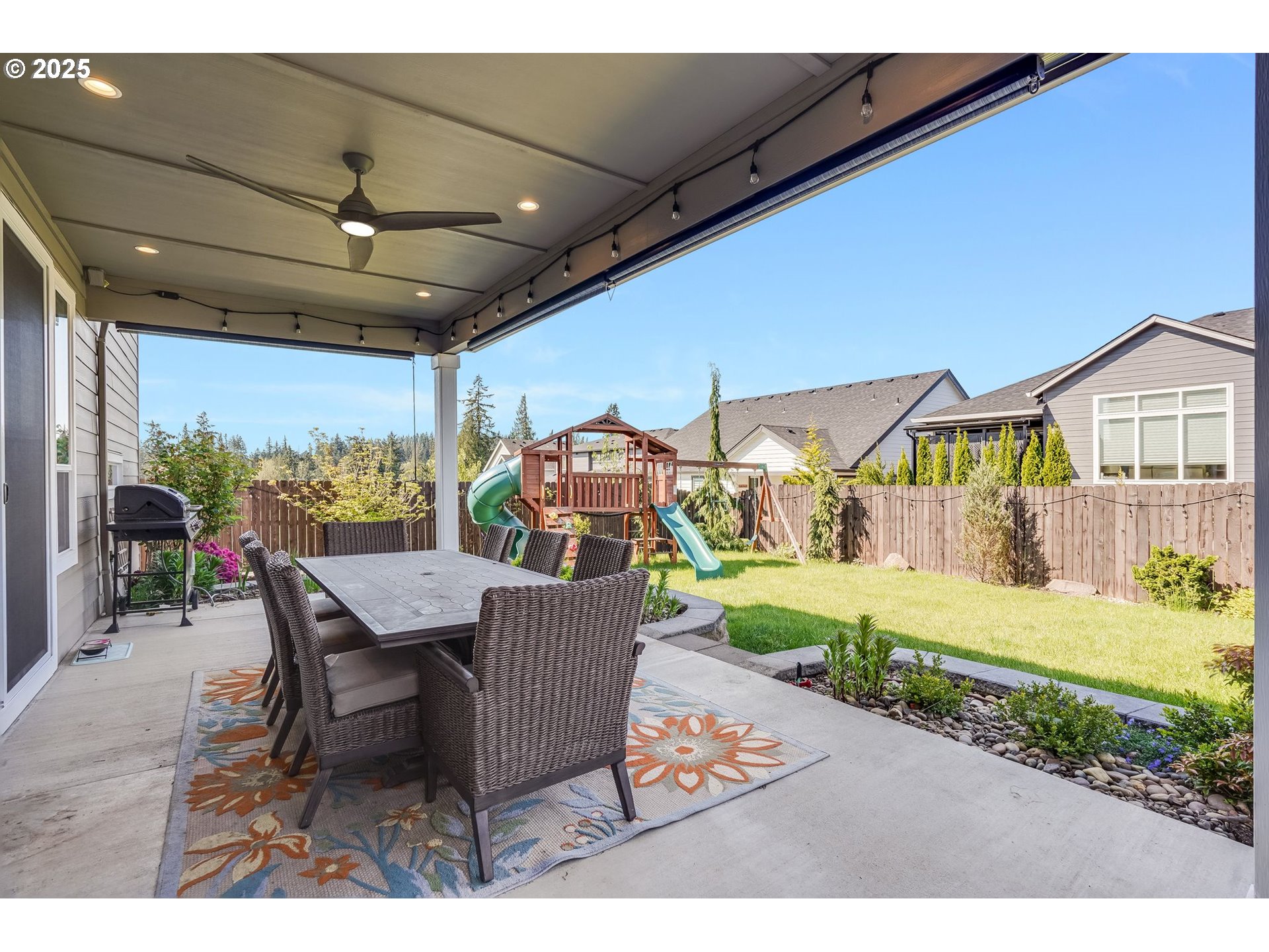 1709 South 43rd Place Ridgefield, WA 98642 - Photo 22 of 24 a view of a patio with table and chairs and potted plants
