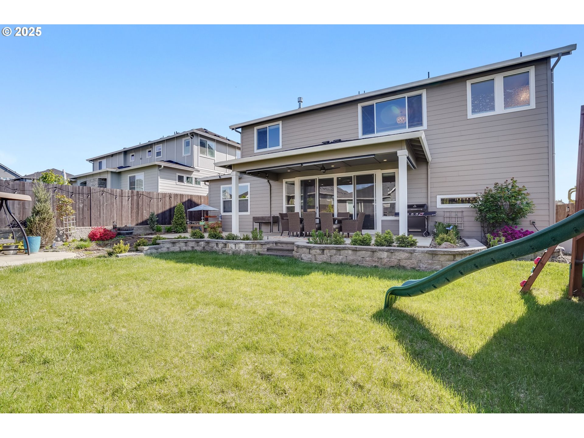 1709 South 43rd Place Ridgefield, WA 98642 - Photo 24 of 24 a view of a house with swimming pool lawn chairs and a yard