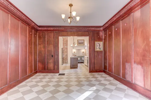 a view of a bedroom with a bed and a chandelier