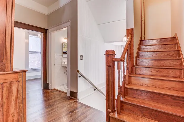 a view of entryway with wooden floor and stairs