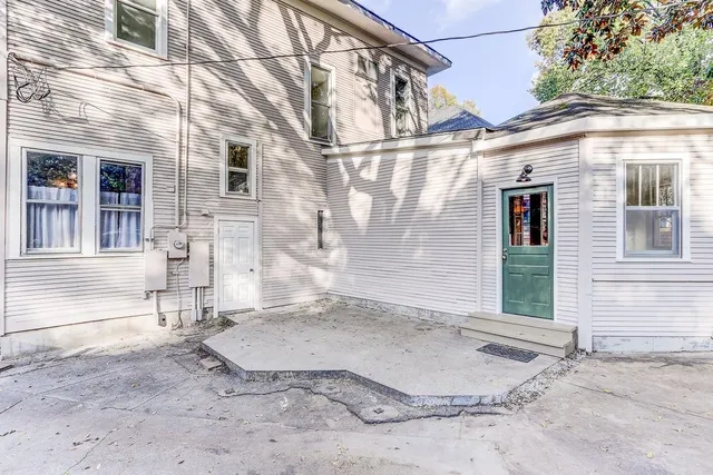 a view of a brick house with many windows