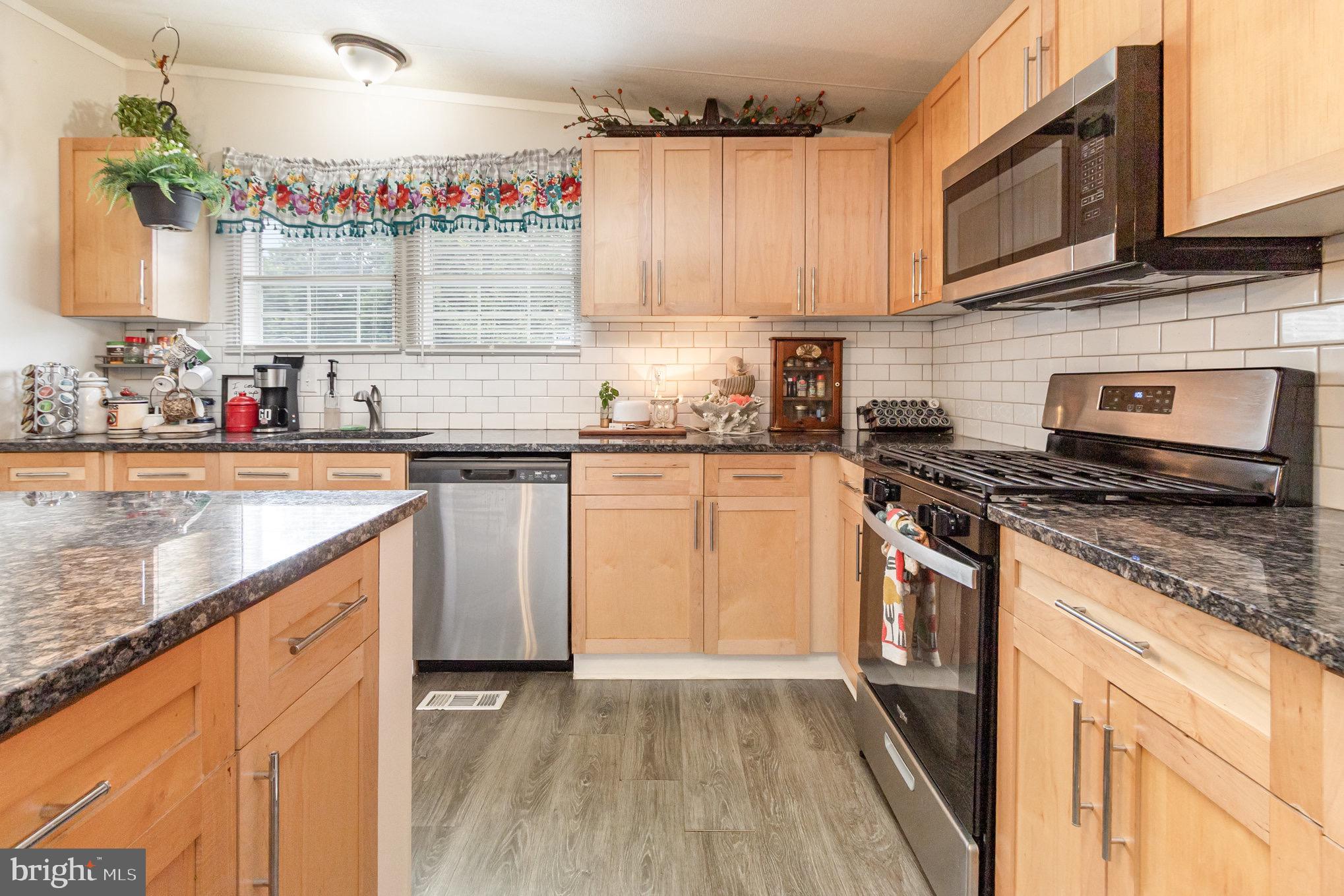 4041 Conowingo Road, Unit 30 Darlington, MD 21034 - Photo 12 of 40 a kitchen with stainless steel appliances granite countertop a sink stove and cabinets