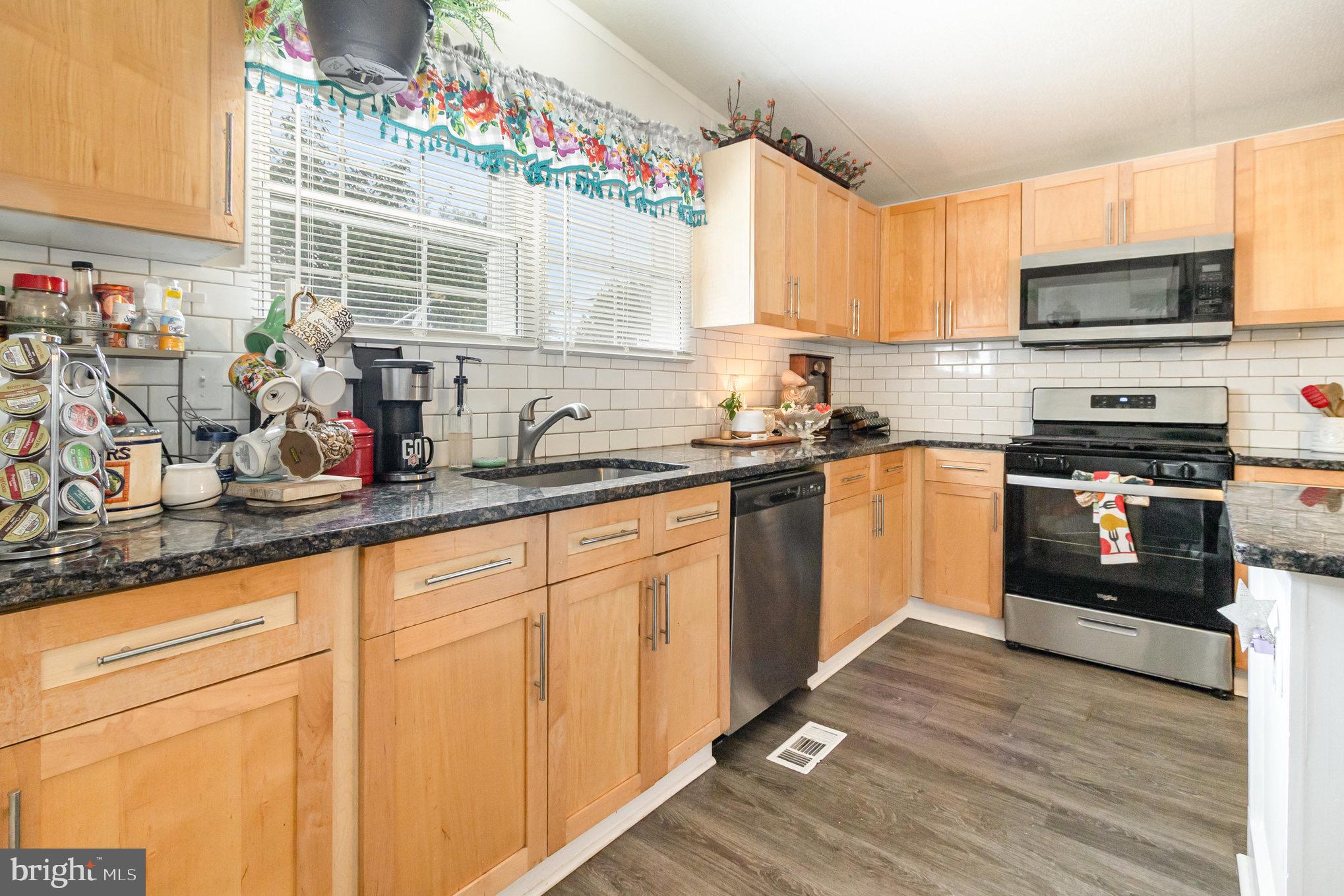 4041 Conowingo Road, Unit 30 Darlington, MD 21034 - Photo 13 of 40 a kitchen with stainless steel appliances granite countertop a sink and a stove