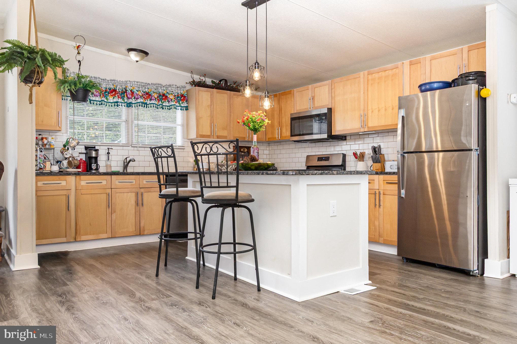4041 Conowingo Road, Unit 30 Darlington, MD 21034 - Photo 16 of 40 a kitchen with sink cabinets and wooden floor