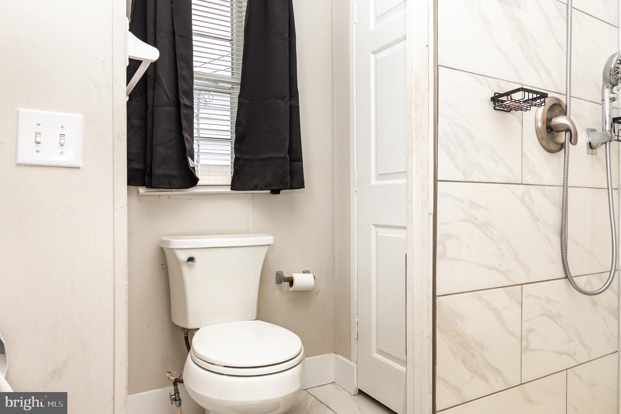 4041 Conowingo Road, Unit 30 Darlington, MD 21034 - Photo 20 of 40 a white toilet sitting next to a bathroom and a shower